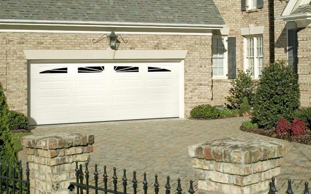 A white Amarr Heritage long-panel garage door with a row of windows on a brick house