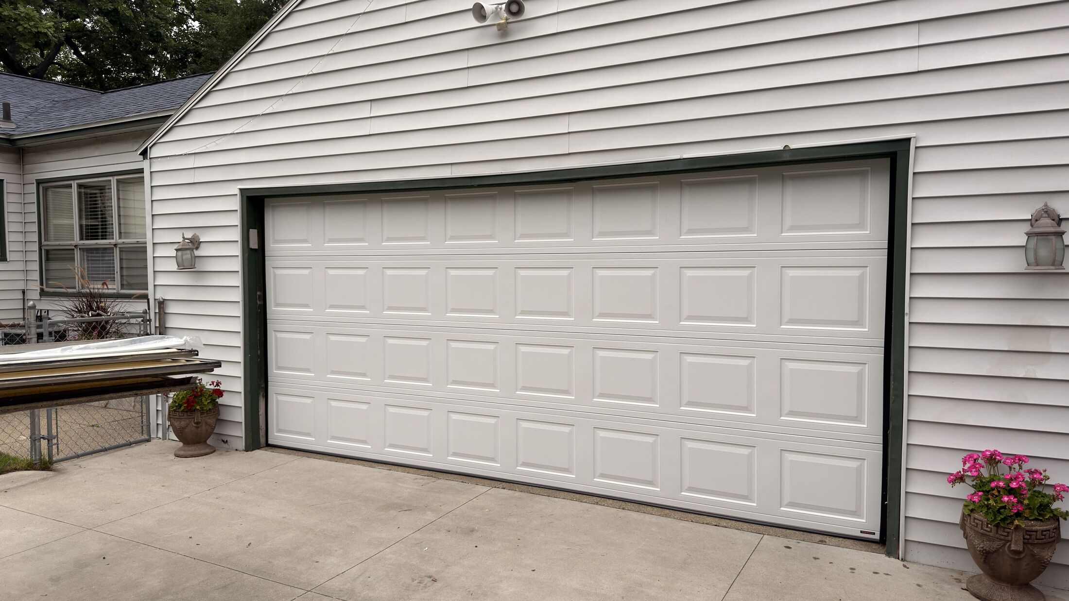 The same garage after: a new white raised-panel door