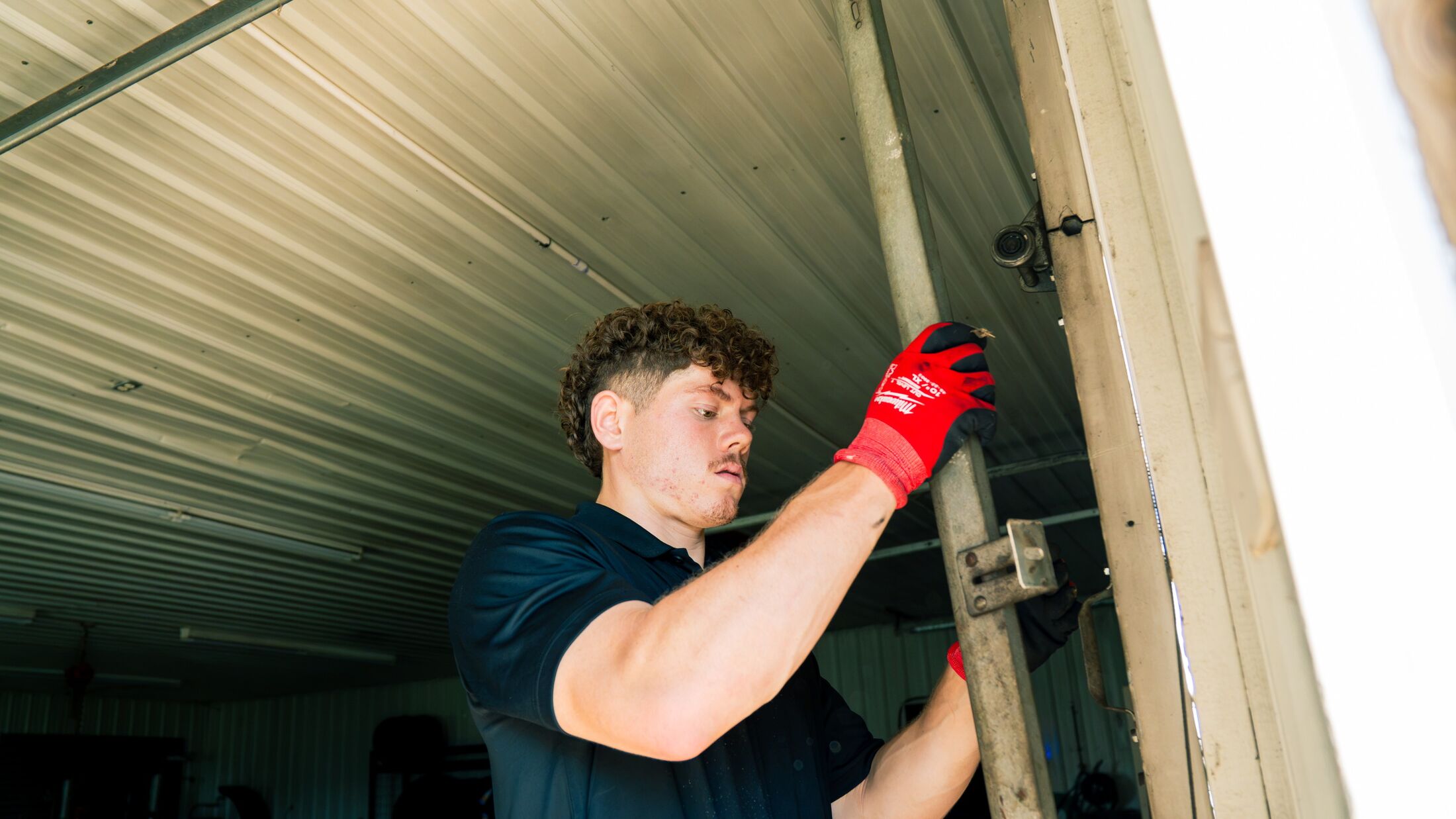 An Elevation technician at an open garage door on a job in the Grand Rapids metro
