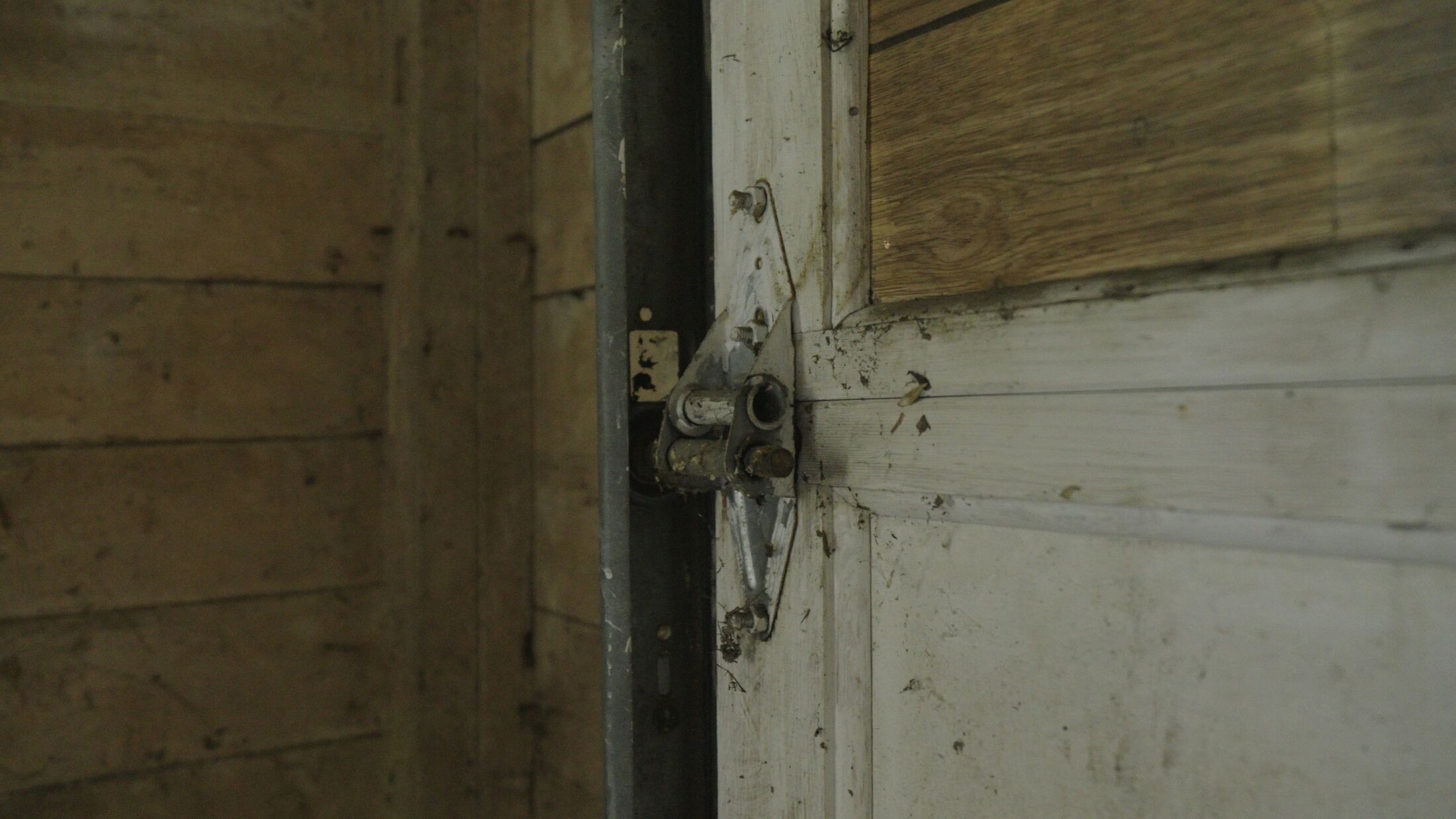 The torsion shaft and end bearing plate above a garage door, where a broken spring is replaced