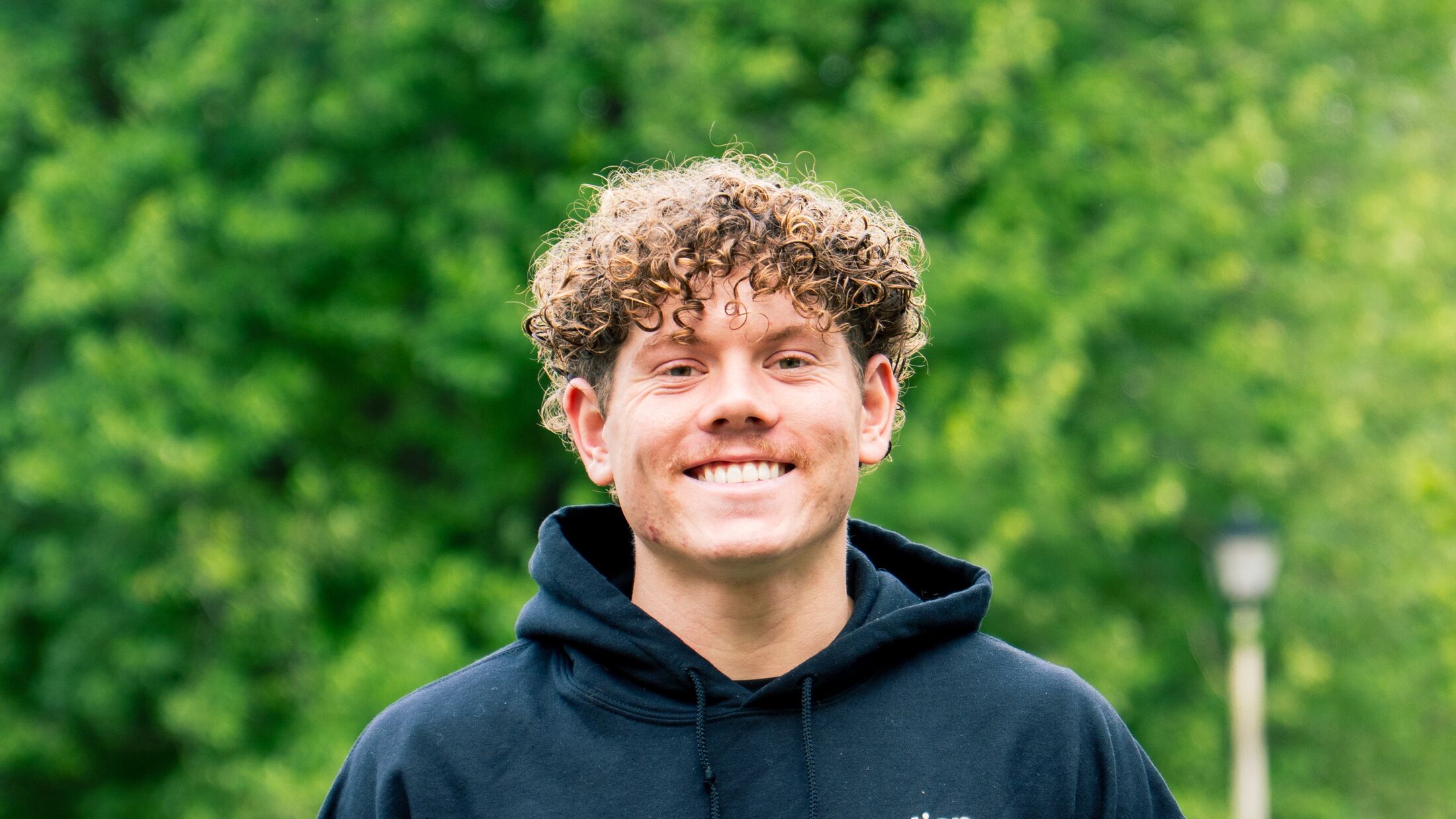 An Elevation team member in a branded hoodie outside on a job in the Grand Rapids metro