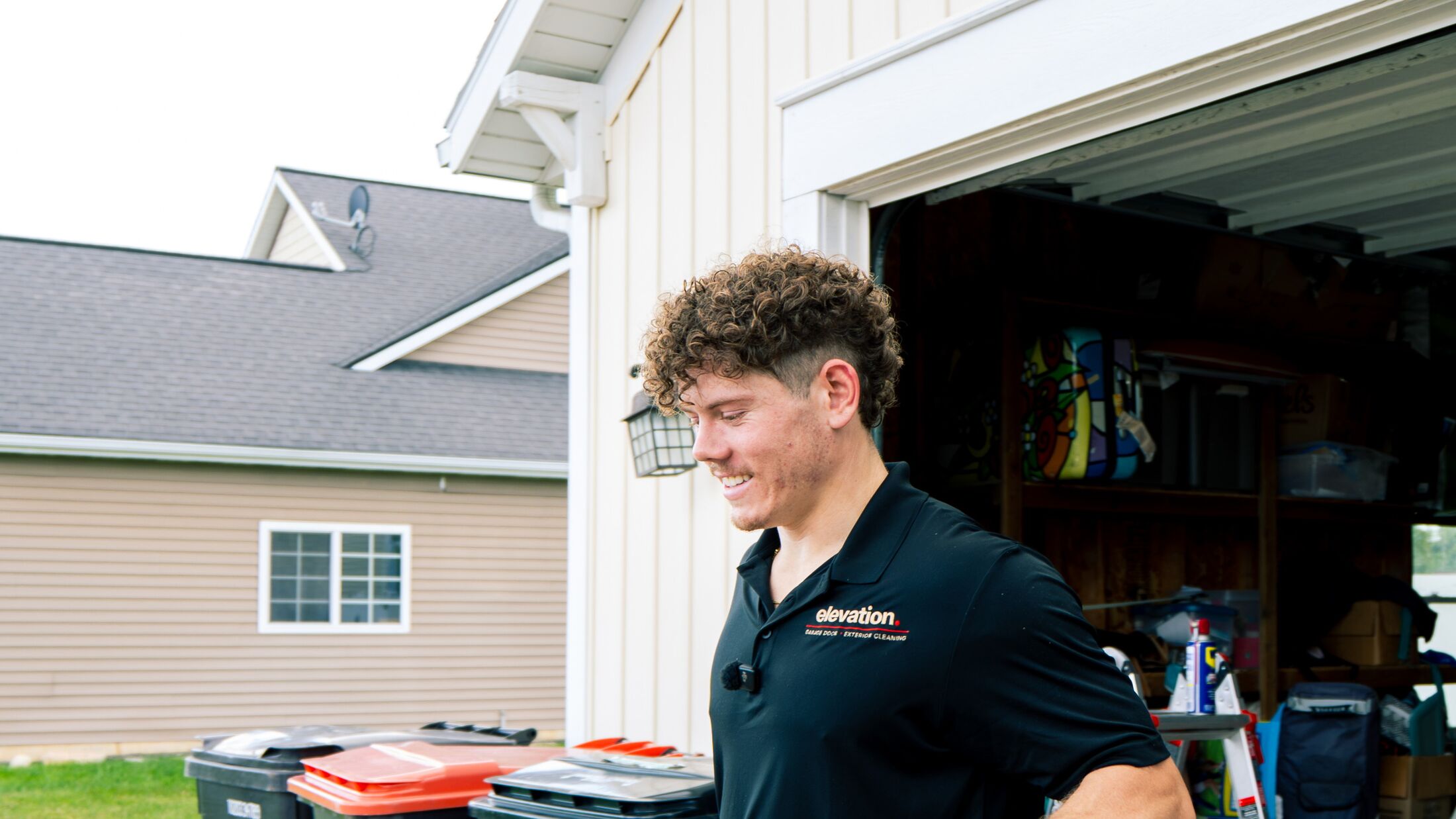 An Elevation technician arriving at a customer's home in the Grand Rapids metro with a tool case and ladder